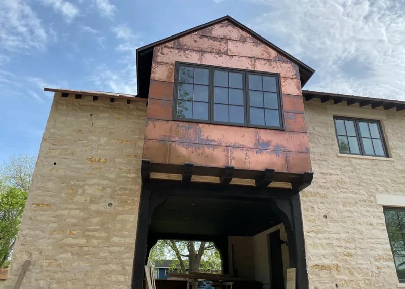 Copper metal panel facade on a stone building for Skylight Installation in Milton